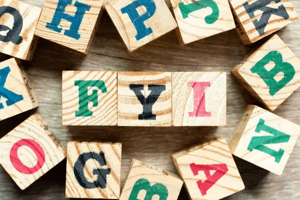image of fyi abbreviation written in wooden blocks