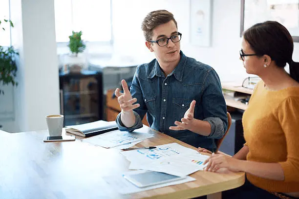 image of two people making a conversation with prepositional verbs